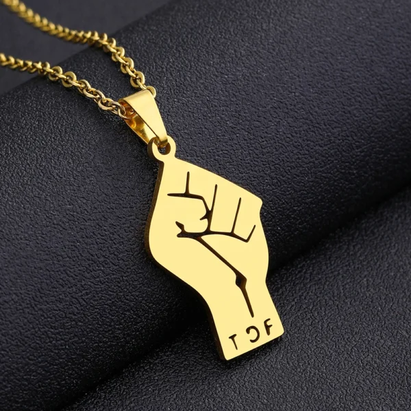 Gold chain with raised fist pendant.