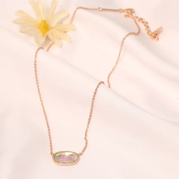 Rose gold necklace with iridescent pendant.