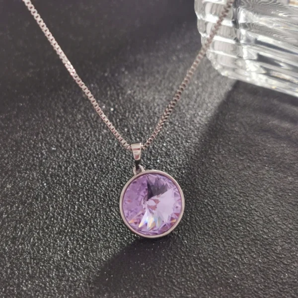 Silver chain with purple gemstone pendant.