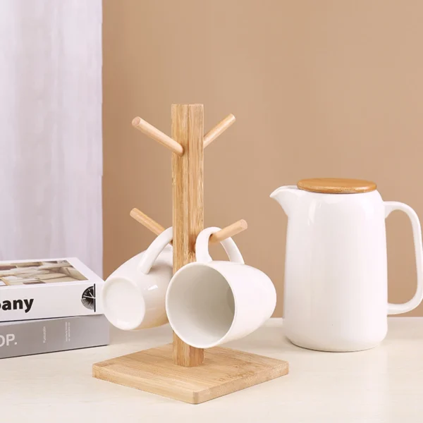 Wooden mug rack with two mugs and a teapot.