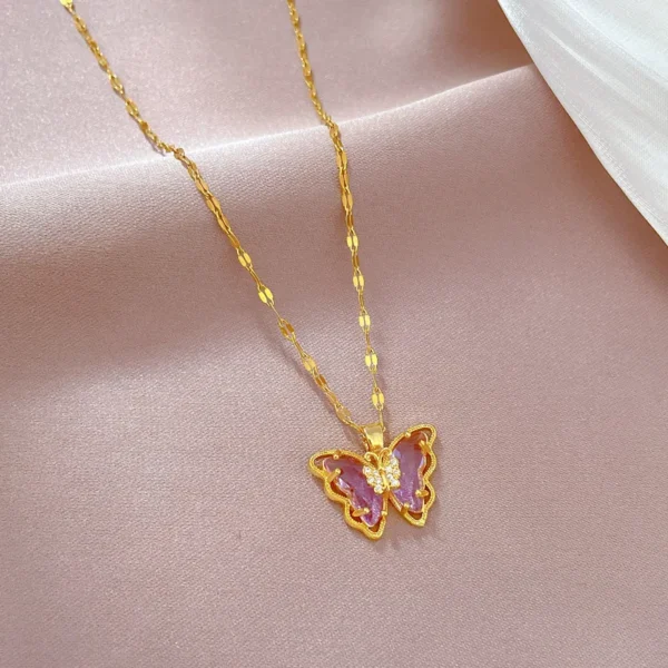 Gold butterfly pendant necklace with purple stone.