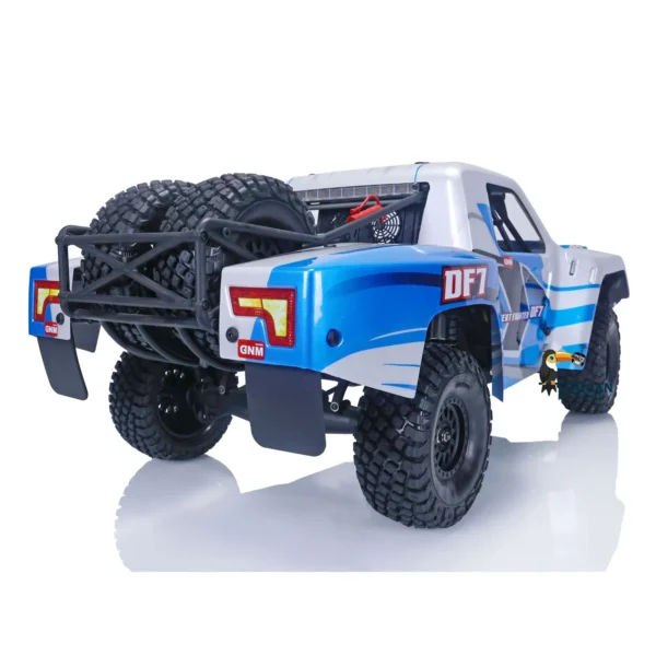 Blue and white off-road truck with spare tire.