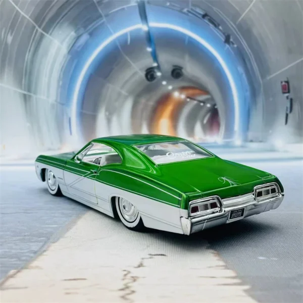 Green and white model car in a tunnel.