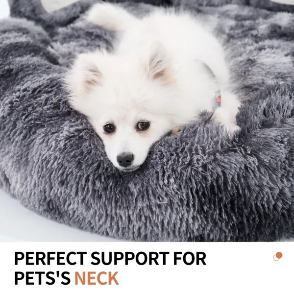 White dog resting on a gray bed.