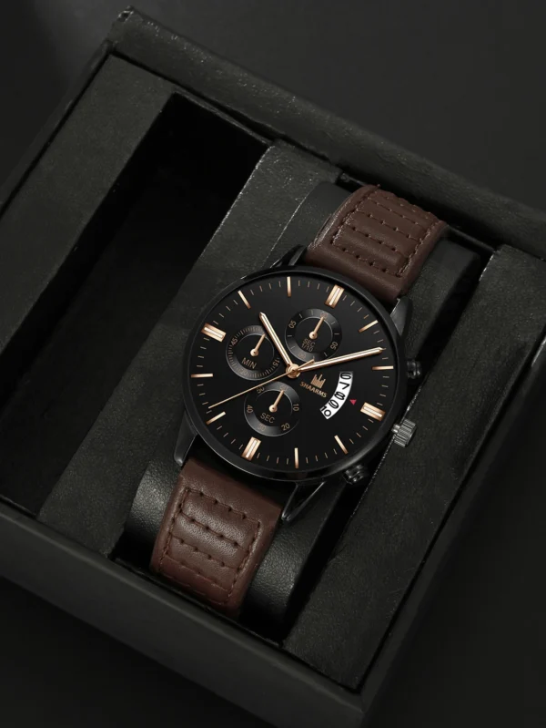 Black analog watch with brown leather strap.