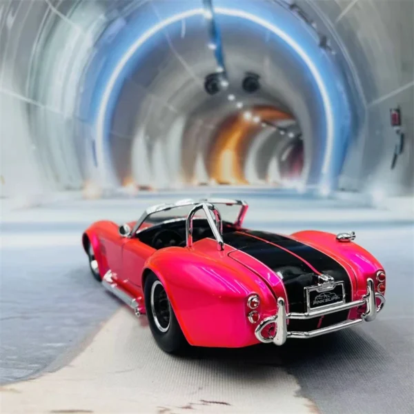 Pink Cobra model car in tunnel.