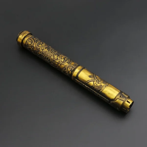 Ornate gold pen with floral design.