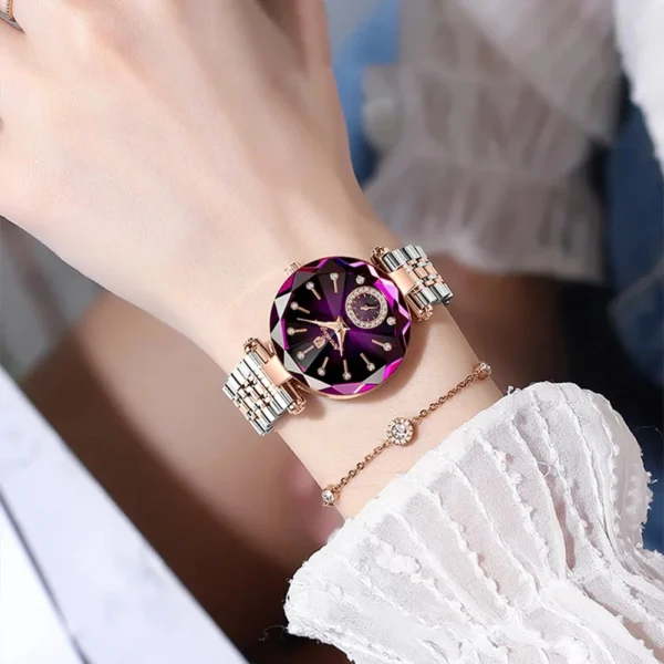 A purple and gold jeweled wristwatch.