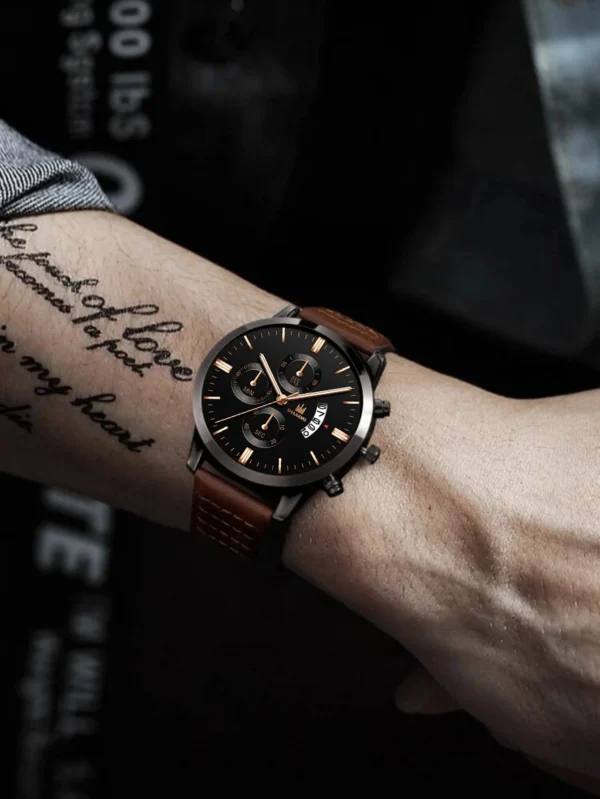 Man's wrist wearing a brown leather watch.