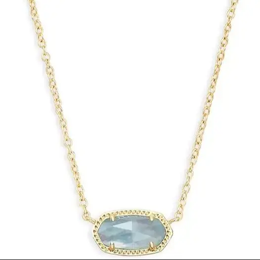 Gold chain necklace with oval gemstone pendant.