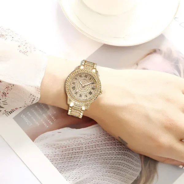 Gold watch with diamond accents on wrist.