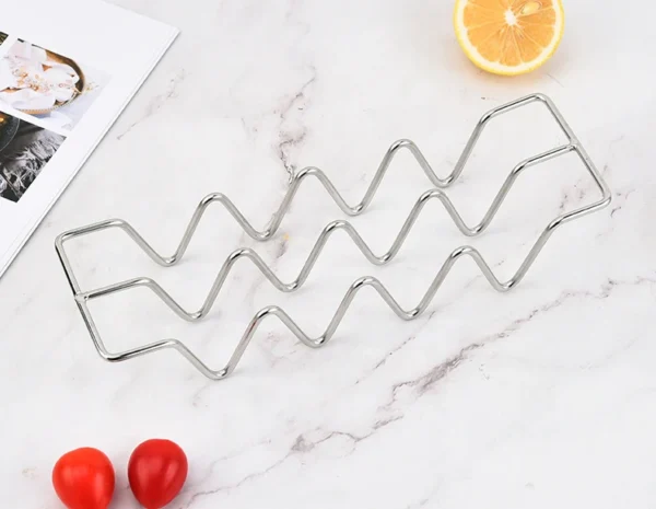 Stainless steel wavy grill rack for cooking.