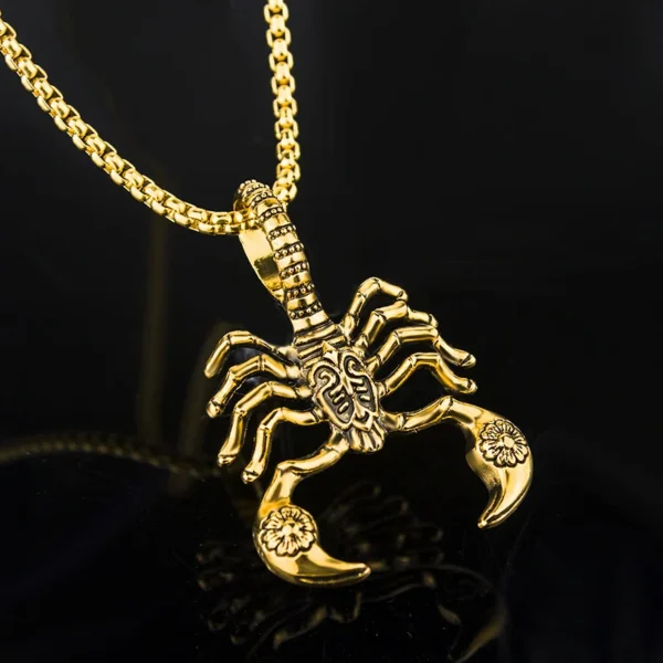 Gold scorpion pendant necklace on chain.