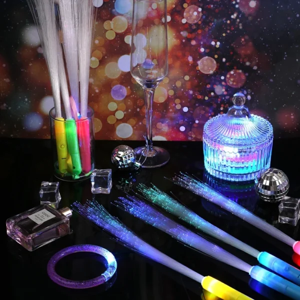 Colorful fiber optic light wands on table.