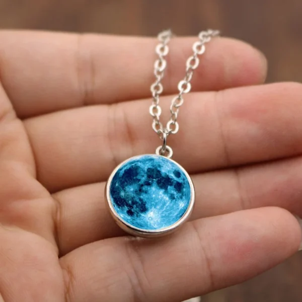 Silver necklace with blue moon pendant.