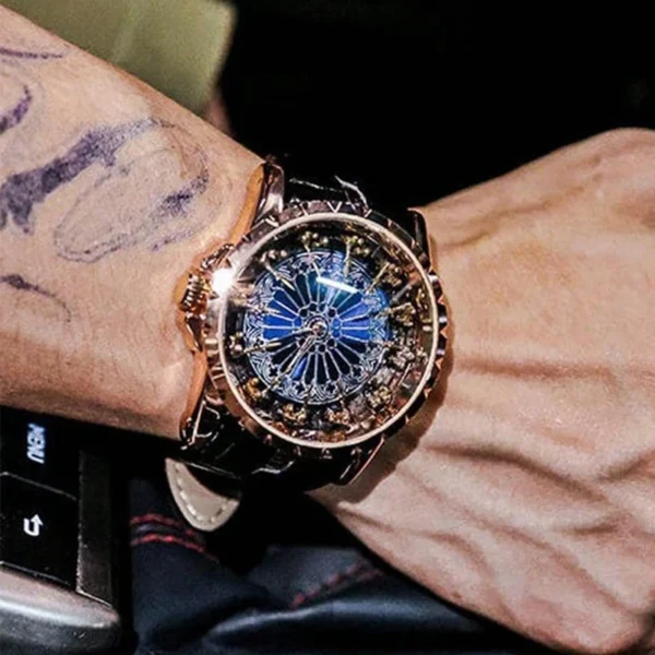 Person wearing a gold and blue watch.