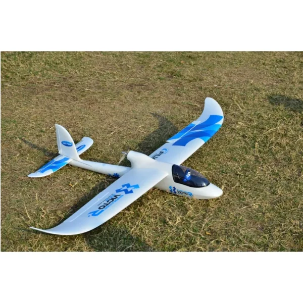 White and blue RC glider airplane on grass.