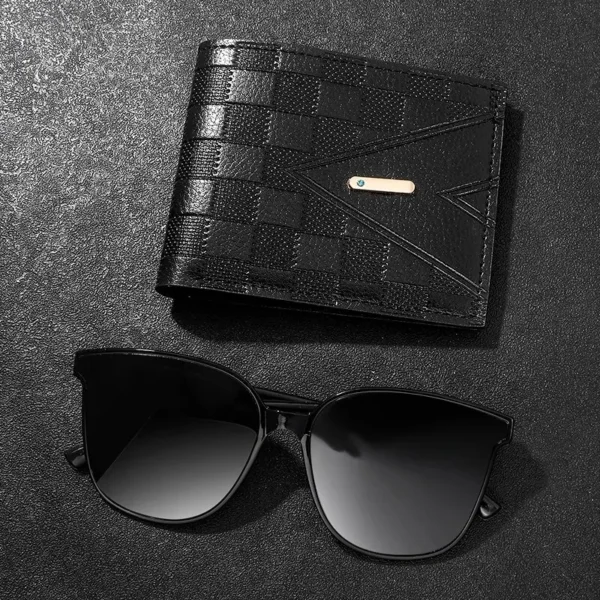 Black wallet and sunglasses on a black background.