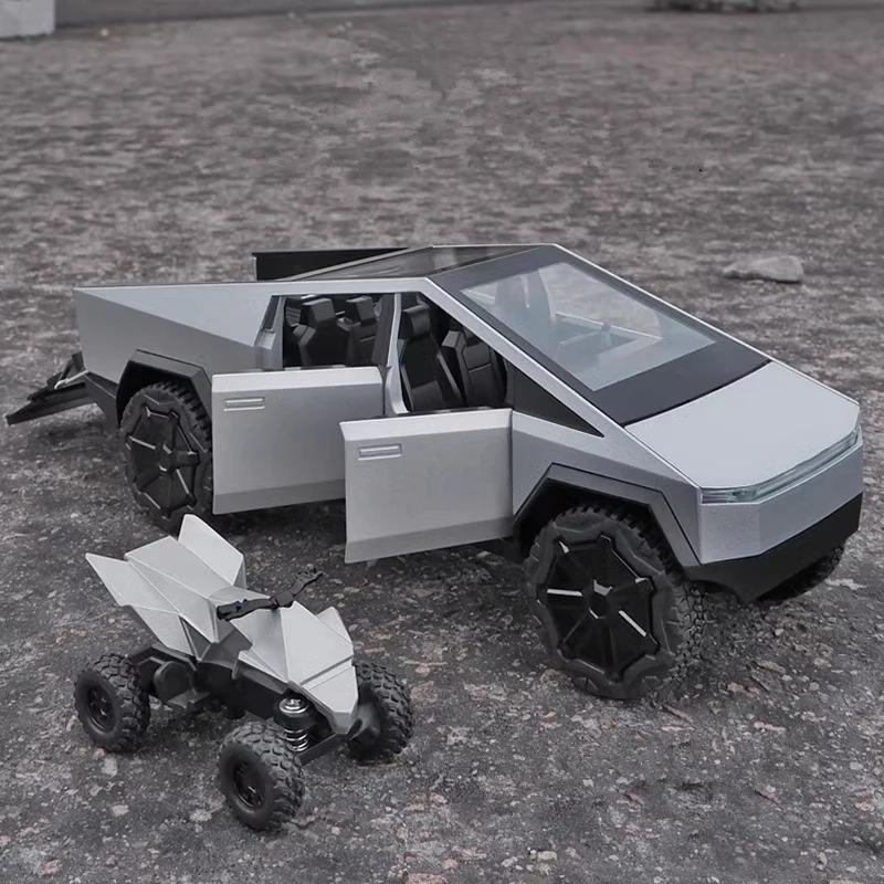 Silver Tesla Cybertruck with a quad bike.