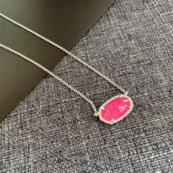 Silver chain with a pink gemstone pendant.