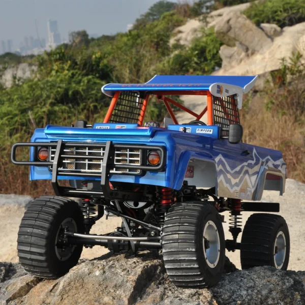 Blue and white off-road truck on rocks.