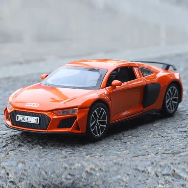 Orange Audi R8 toy car on pavement.