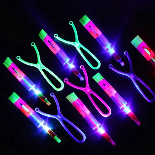 Colorful glowing slingshot toys on black background.