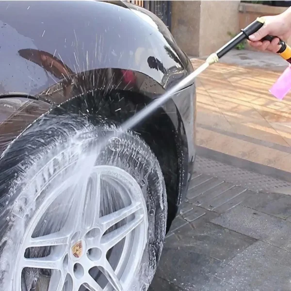 Car wheel being washed with water.