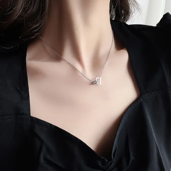 Silver necklace with a letter D pendant.