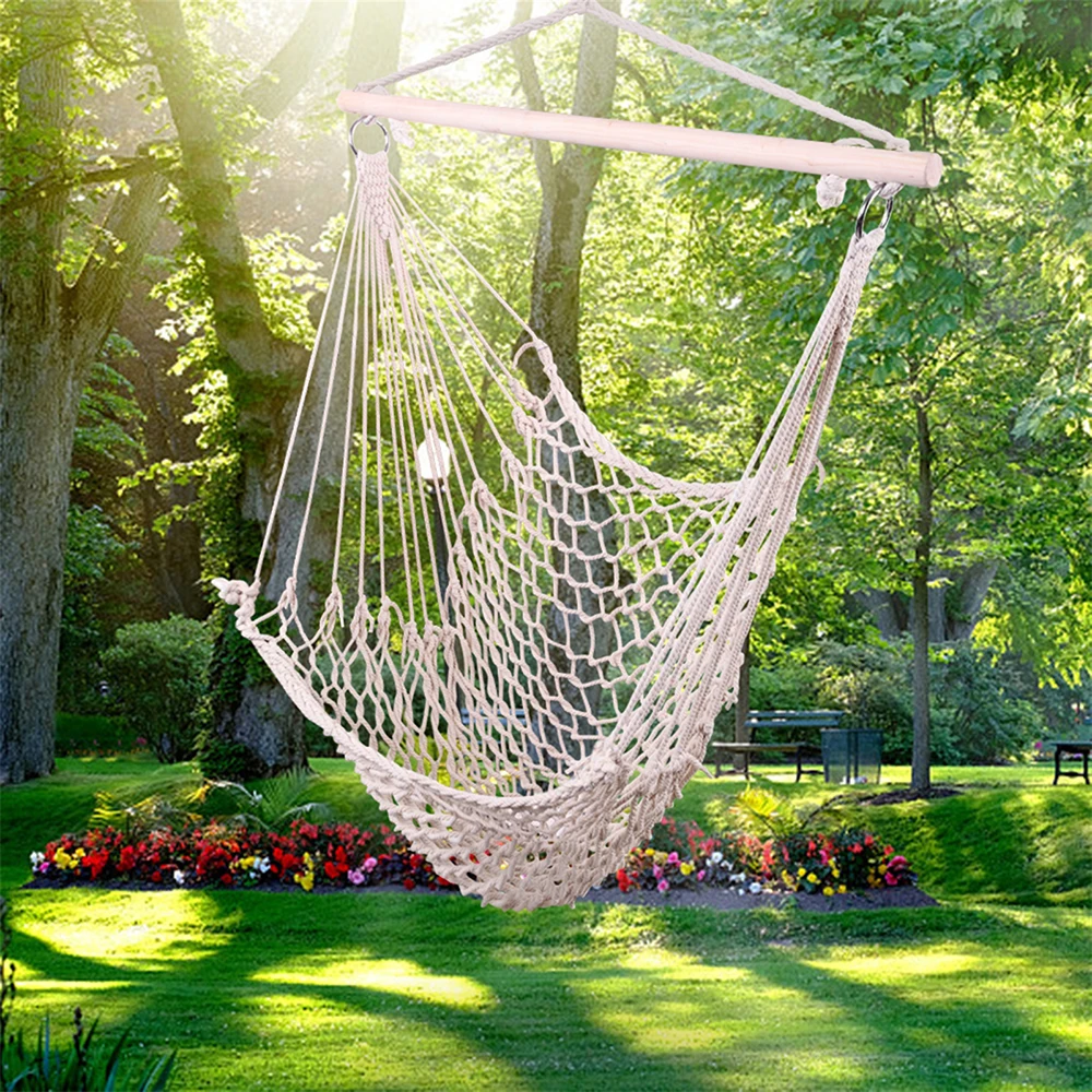 White hanging rope hammock chair outdoors.