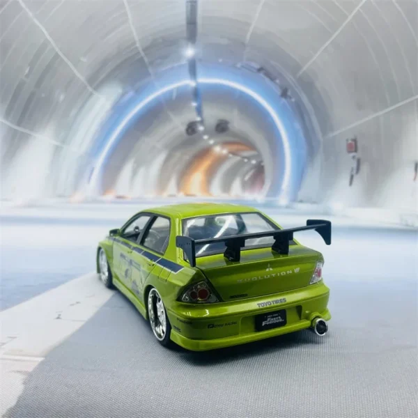 Green Mitsubishi Evolution in tunnel.