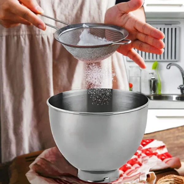 Sieving flour into a mixing bowl.