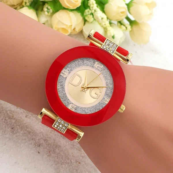 Red and gold wristwatch with DG logo.