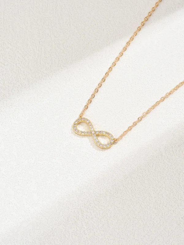 Gold infinity necklace with diamonds.