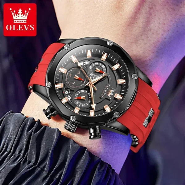 Black and red chronograph wristwatch on wrist.