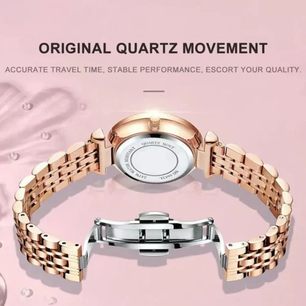 Rose gold analog watch with metal band.