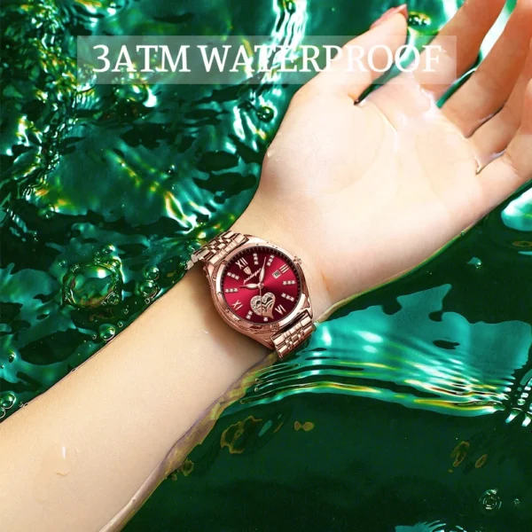 Woman's wrist with red waterproof watch.