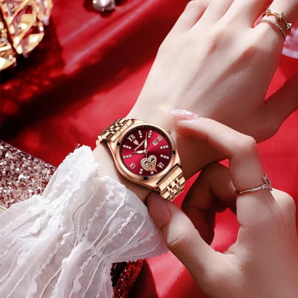 Woman's wrist wearing a rose gold watch.