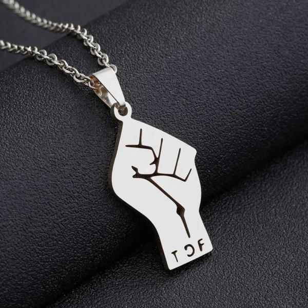 Silver chain necklace with raised fist pendant.