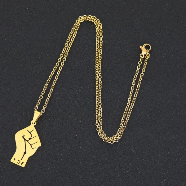 Gold chain necklace with fist pendant