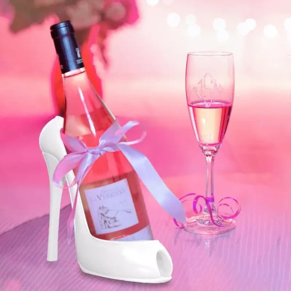 White shoe shaped wine holder with pink wine.