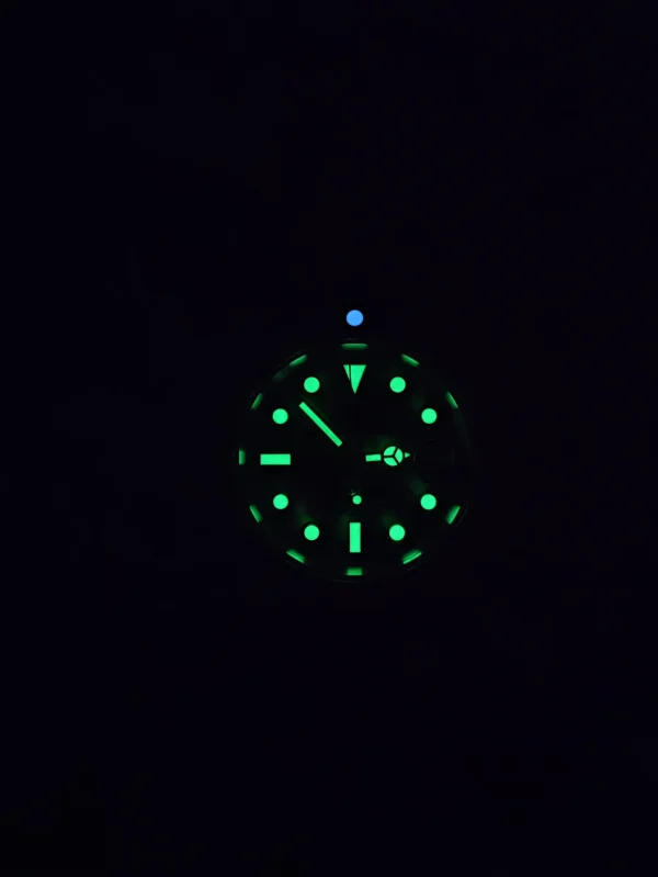 Green glowing watch face in the dark.