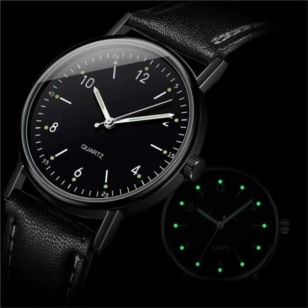 Black leather watch with glowing hands.