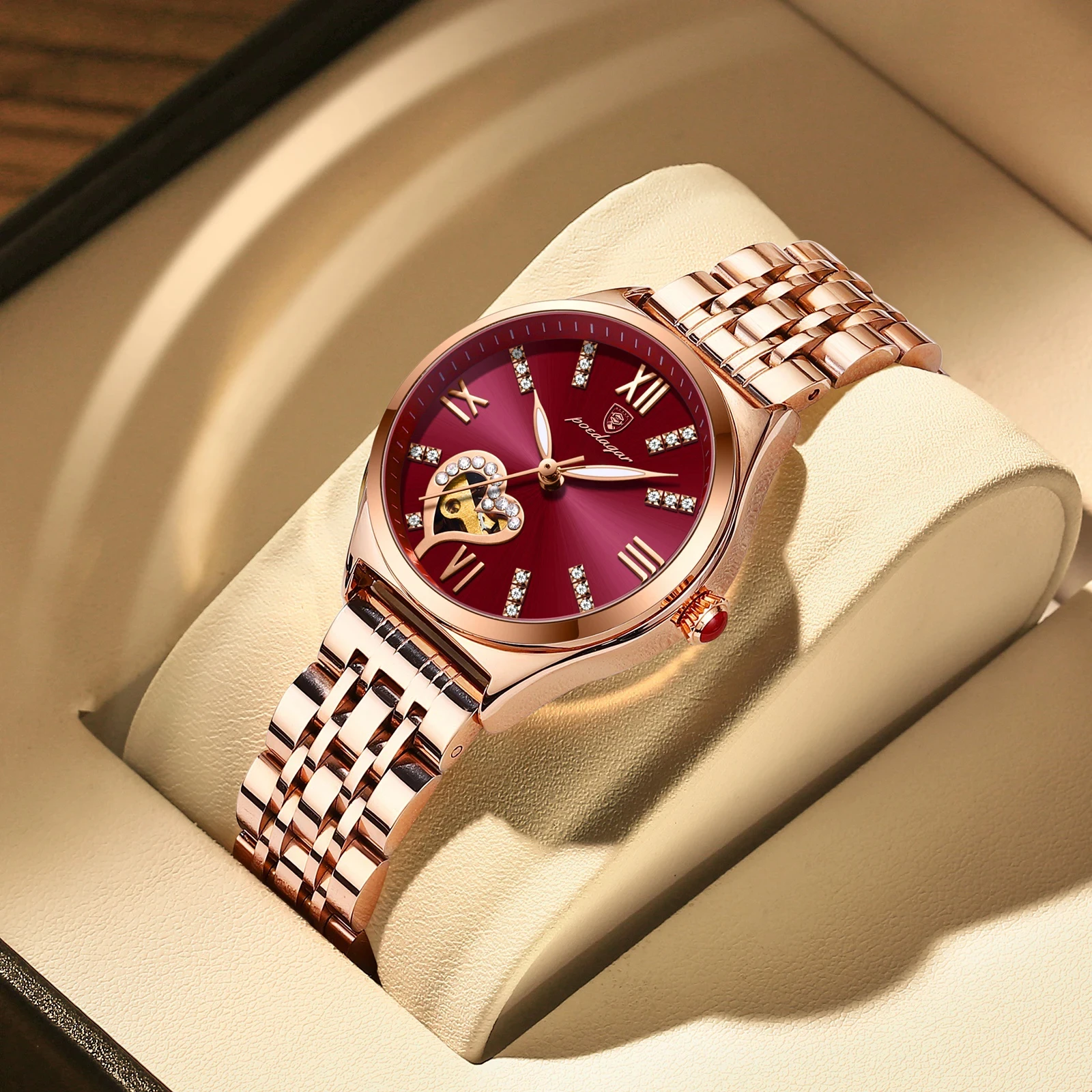 Gold watch with red face and diamonds.