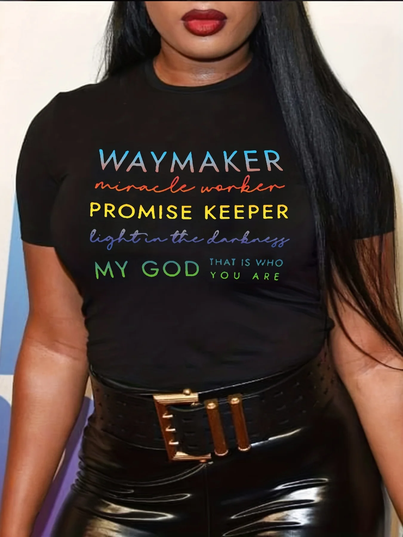 Woman wearing a black shirt with a religious quote.