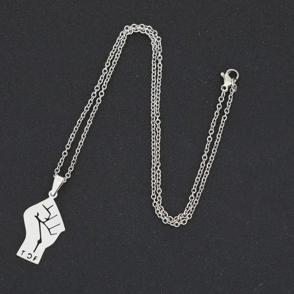 Silver chain necklace with fist pendant.