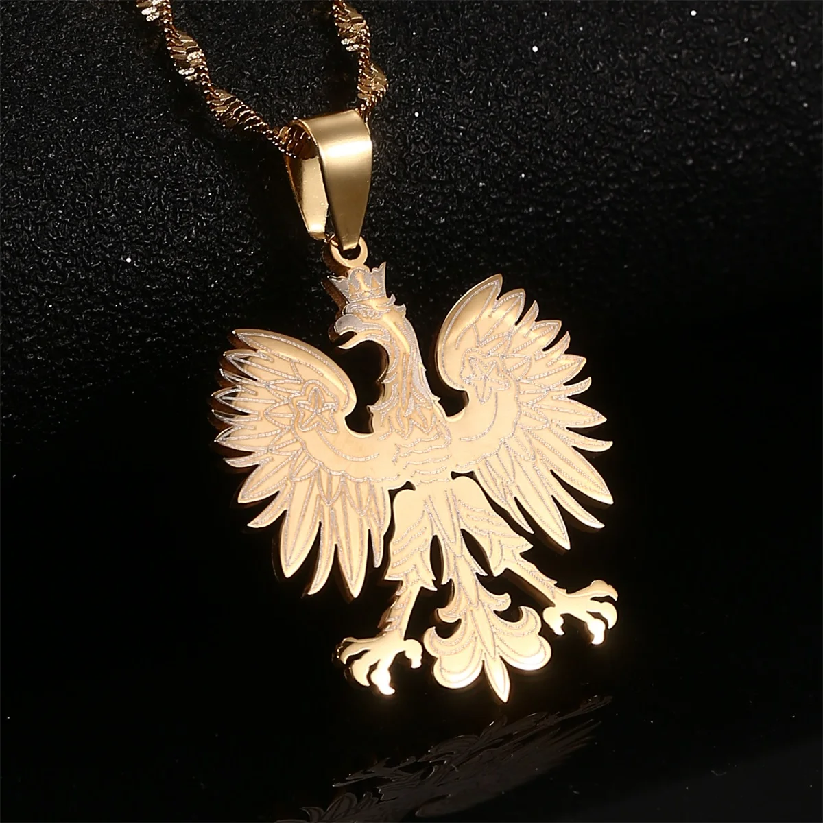 Gold eagle pendant on chain necklace.