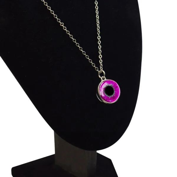 Silver chain necklace with pink eye pendant.