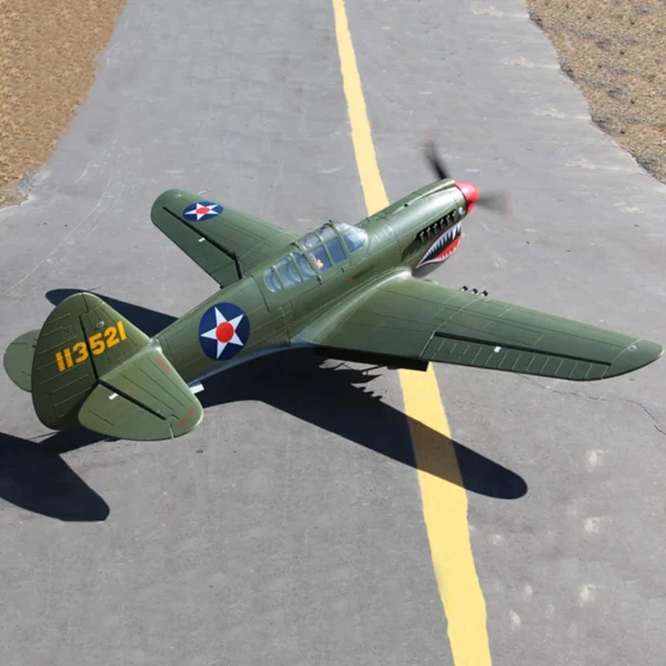 Green and yellow P-40 Warhawk on tarmac.