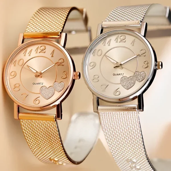 Two gold and silver heart-shaped quartz watches.